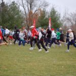 Group of volunteers running in a field.