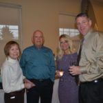 Group of older adults at an event posing for a photo together.